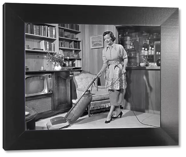 Apron housewife vacuuming den