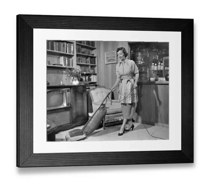 Framed Print : Apron housewife vacuuming den Framed Print : Apron housewife vacuuming den