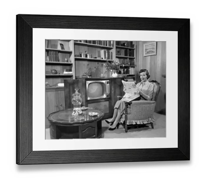 Framed Print : Woman relaxing at home with newspaper Framed Print : Woman relaxing at home with newspaper
