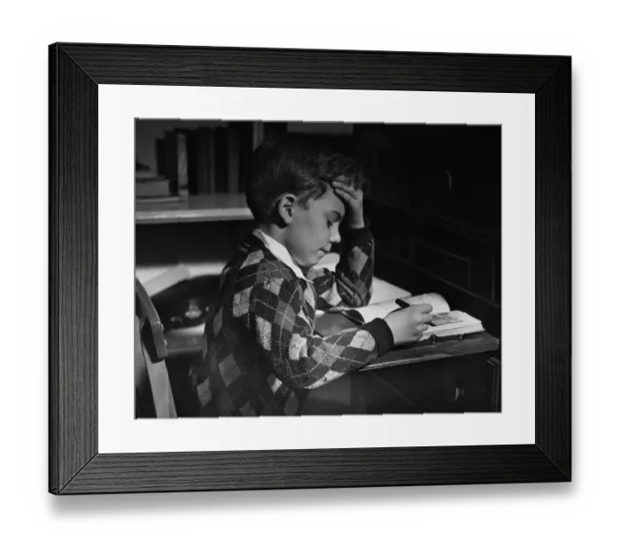 Framed Print : Homework. A little boy reading his homework, circa 1950 Framed Print : Homework. A little boy reading his homework, circa 1950