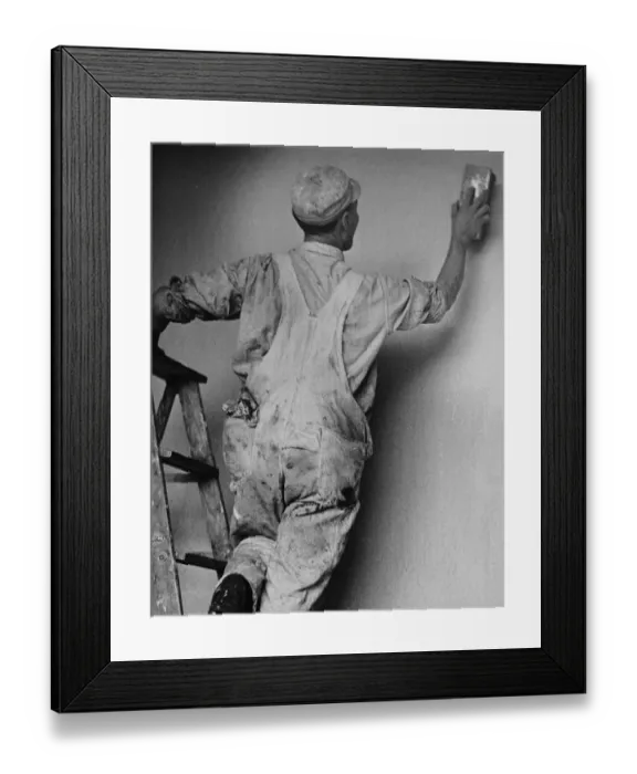 Framed Print : Decorator. A decorator smooths the plaster of a new wall, circa 1950 Framed Print : Decorator. A decorator smooths the plaster of a new wall, circa 1950