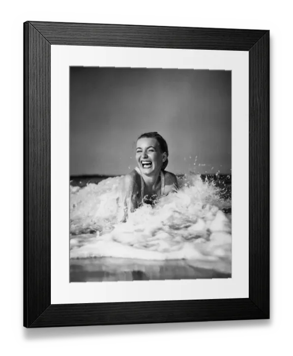 Framed Print : Young woman lying in surf, laughing Framed Print : Young woman lying in surf, laughing