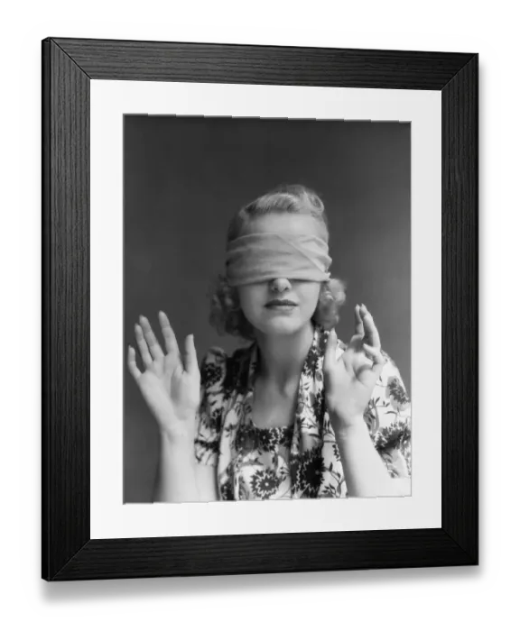 Framed Print : Blindfolded woman holding hands out in front of herself. (Photo by H