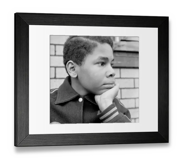 Framed Print : African-American teenage boy resting chin in hand, looking off to side Framed Print : African-American teenage boy resting chin in hand, looking off to side