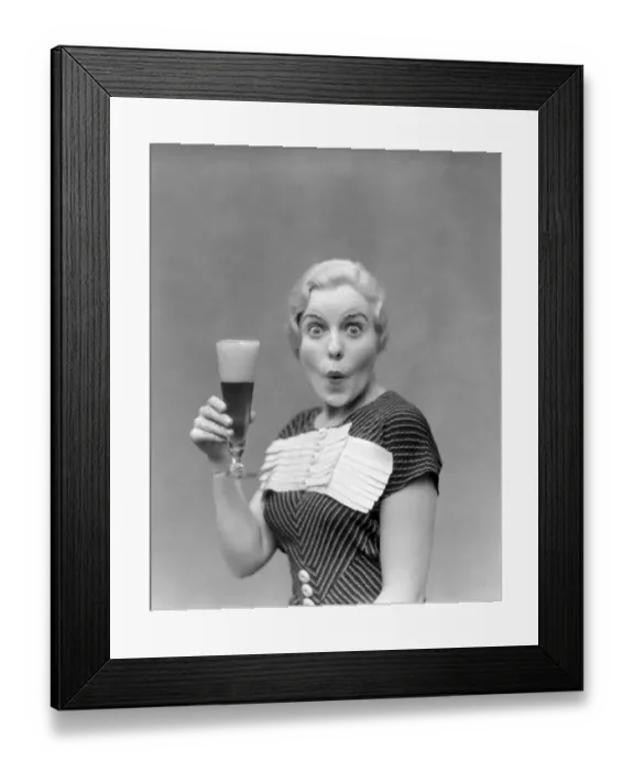 Framed Print : Blonde Woman In Black Dress With Stripes & White Buttons & Trim Holding A Pilsner Glass