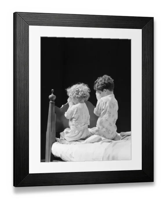 Framed Print : Boy and girl kneeling by bed praying, rear view Framed Print : Boy and girl kneeling by bed praying, rear view