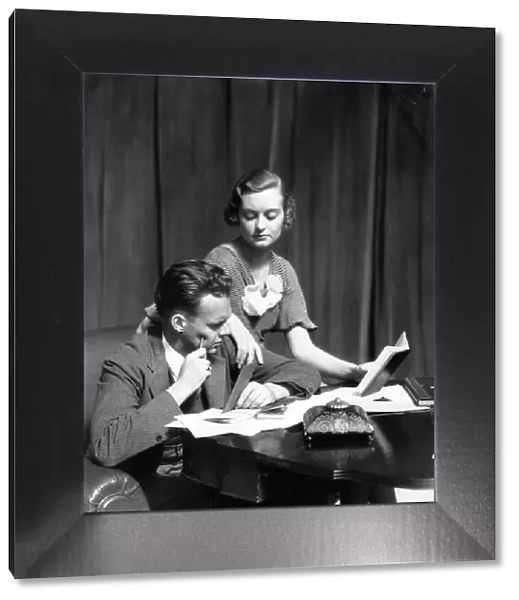 Couple At A Desk With Check Books Papers Balance Books & Inkwell The Woman Wearing A