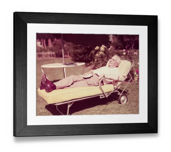 Framed Print : Elderly man relaxing on sun lounger in backyard. (Photo by H Framed Print : Elderly man relaxing on sun lounger in backyard. (Photo by H