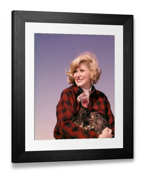 Framed Print : Smiling blonde woman holding thanksgiving turkey Framed Print : Smiling blonde woman holding thanksgiving turkey