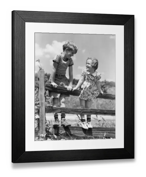 Framed Print : Boy and girl standing on split rail fence, looking at each other Framed Print : Boy and girl standing on split rail fence, looking at each other