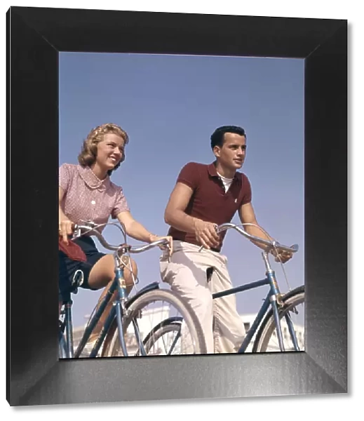 Teenage Boy And Girl On Bicycles