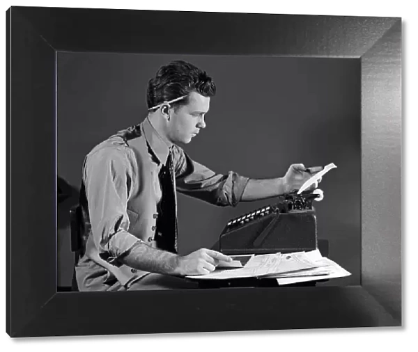Man In Office At Adding Machine, Looking At Tape