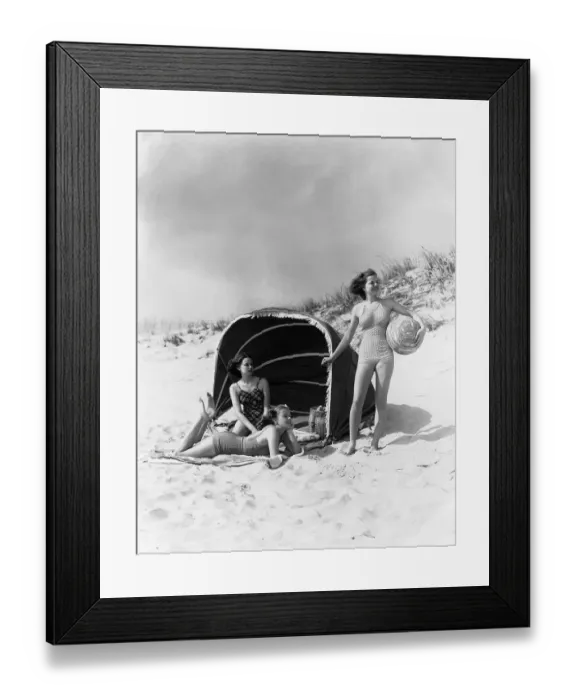 Framed Print : Three Women On Beach Two Are Under Canvas Sun Wind Screen With Fringe Other Is Standing Framed Print : Three Women On Beach Two Are Under Canvas Sun Wind Screen With Fringe Other Is Standing