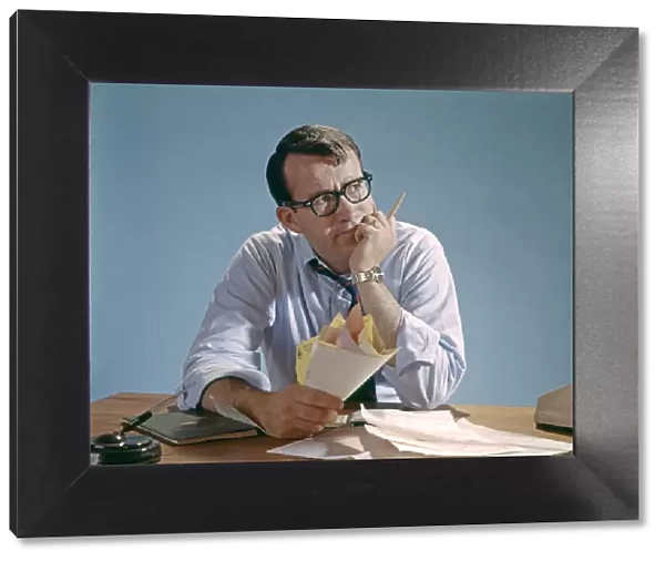 Worried Looking Man With Glasses At Desk Clutching Papers Bills Debt Concern Money Pencil