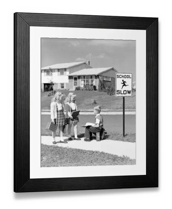 Framed Print : Two girls walking to school, boy sitting on lunchbox. (Photo by H Framed Print : Two girls walking to school, boy sitting on lunchbox. (Photo by H