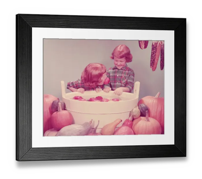 Framed Print : Twin red haired girls bobbing for apples at party. (Photo by H Framed Print : Twin red haired girls bobbing for apples at party. (Photo by H