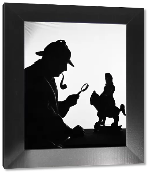 Silhouette of man wearing deerstalker, dressed as Sherlock Holmes. (Photo by H