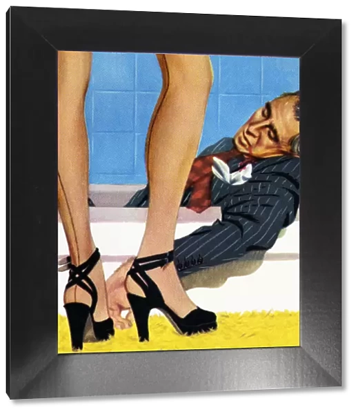 Legs of Woman Standing by Man Lying in a Bathtub