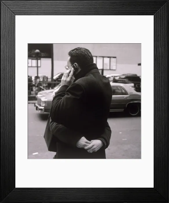 Framed Print : Man talking on cell phone and hugging woman Framed Print : Man talking on cell phone and hugging woman