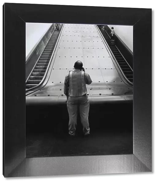 Man at bottom of Path train escalators in New York City