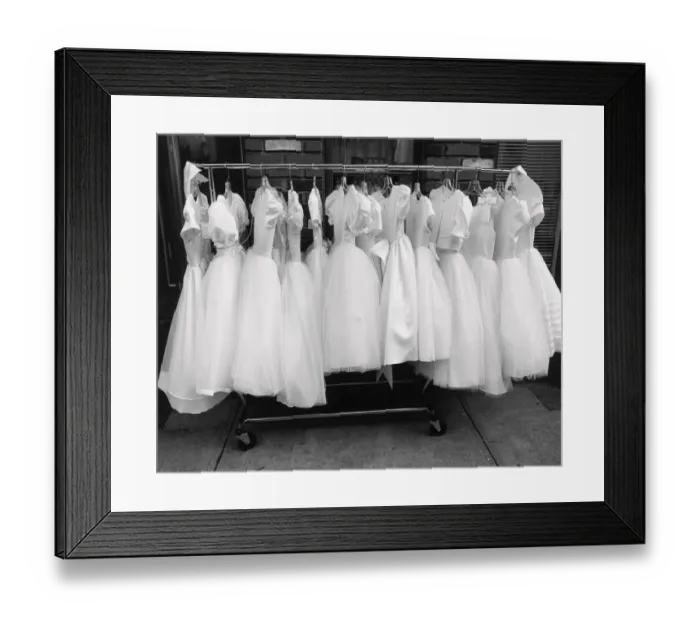 Framed Print : Row of white dresses hanging on rack Framed Print : Row of white dresses hanging on rack