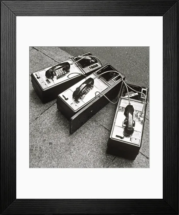 Framed Print : Public phones lying on sidewalk Framed Print : Public phones lying on sidewalk