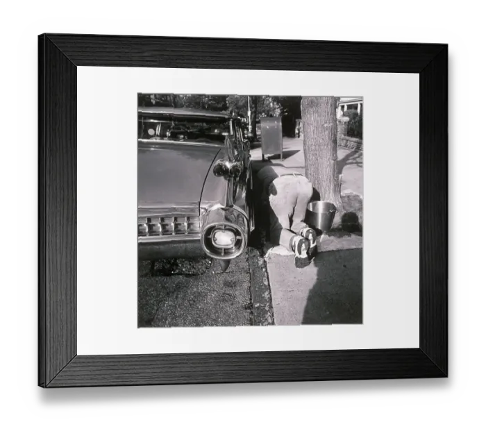 Framed Print : Man kneeling on ground and washing car Framed Print : Man kneeling on ground and washing car