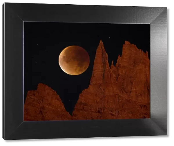 Blood Moon over jagged mountains