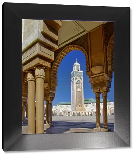 Mosque of Hassan II and minaret through the arches of the square outside it in Casablanca