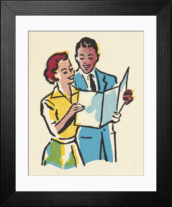 Framed Print : Happy Couple Looking at a Paper Framed Print : Happy Couple Looking at a Paper
