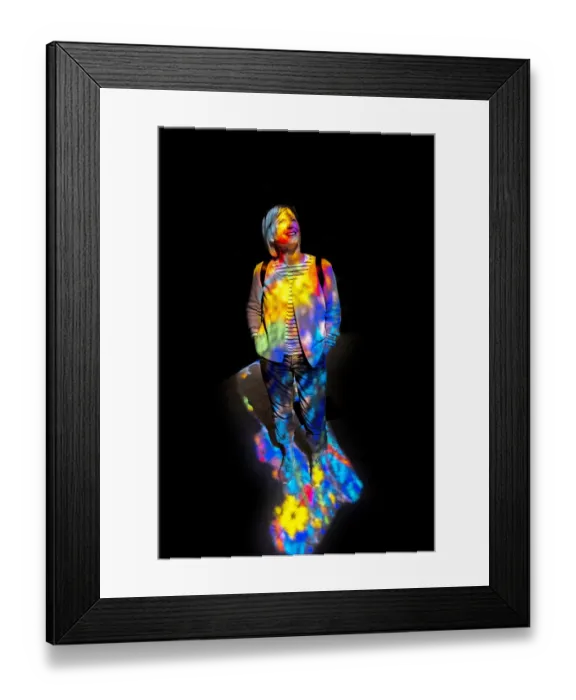 Framed Print : Woman in the colourful light of a stained glass window