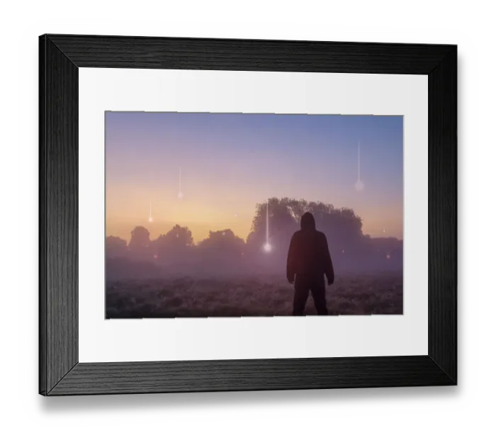 Framed Print : A UFO, supernatural concept. A hooded figure with his back to the camera