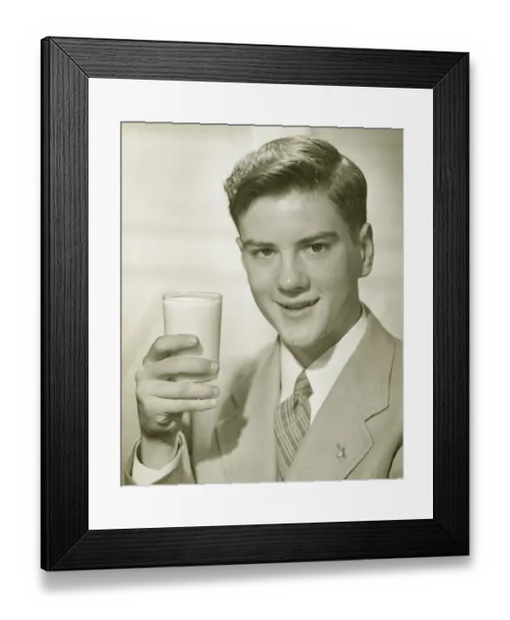 Framed Print : Young man holding glass of milk, (B&W), portrait Framed Print : Young man holding glass of milk, (B&W), portrait