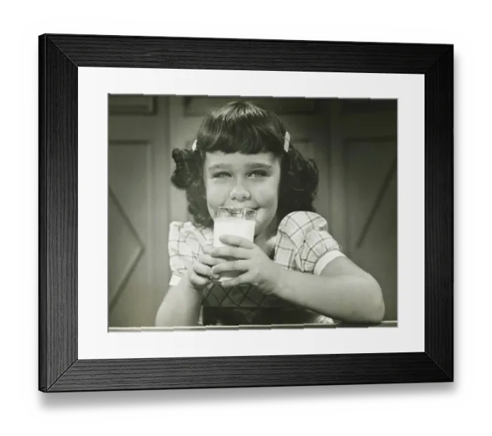 Framed Print : Girl (6-7) sitting at table, drinking milk, (B&W), (Close-up), (Portrait) Framed Print : Girl (6-7) sitting at table, drinking milk, (B&W), (Close-up), (Portrait)