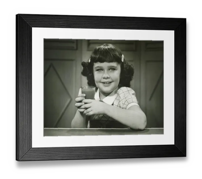 Framed Print : Girl (6-7) sitting at table, holding glass, (B&W), (Close-up), (Portrait) Framed Print : Girl (6-7) sitting at table, holding glass, (B&W), (Close-up), (Portrait)