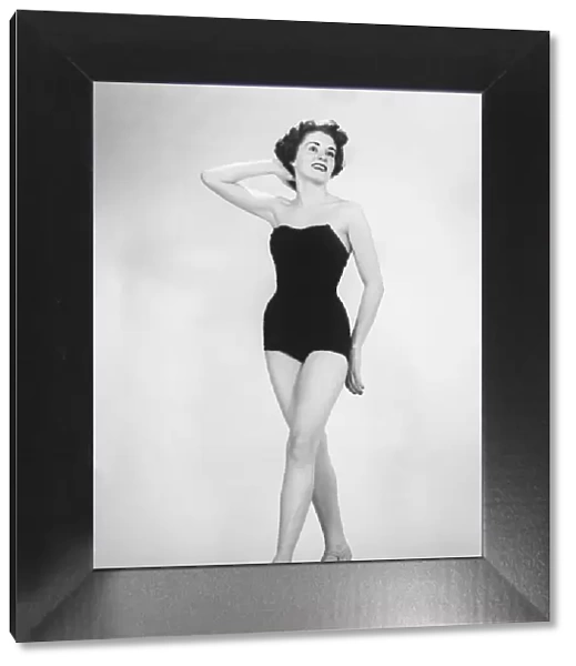 Woman in black corset posing in studio (B&W)