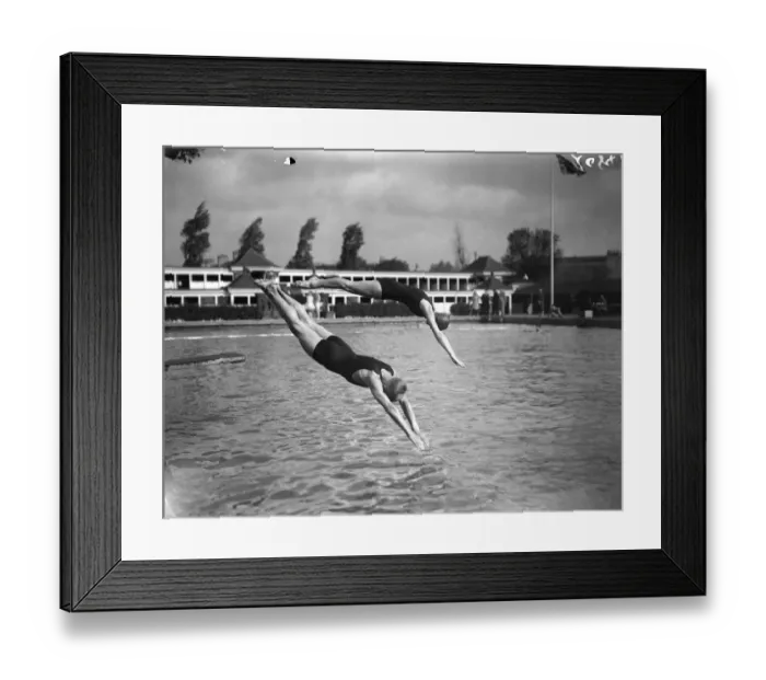Framed Print : Diving. 1929: A man and a woman diving into a pool from a diving board Framed Print : Diving. 1929: A man and a woman diving into a pool from a diving board