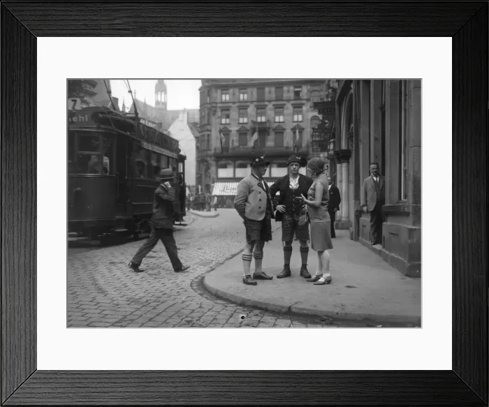 Framed Print : Bavarians. circa 1930: A fashionable woman talks to a couple of men in Framed Print : Bavarians. circa 1930: A fashionable woman talks to a couple of men in