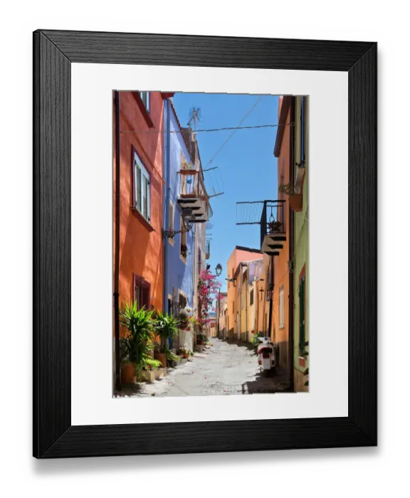 Framed Print : Uphill street with colourful architecture in Bosa, Sardinia, on a sunny day Framed Print : Uphill street with colourful architecture in Bosa, Sardinia, on a sunny day