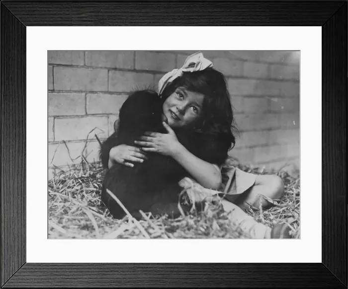 Framed Print : Girl Cuddles Monkey Framed Print : Girl Cuddles Monkey