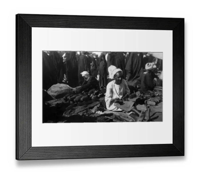Framed Print : Shoemaker. circa 1930: An Egyptian shoe maker plies his trade in the marketplace Framed Print : Shoemaker. circa 1930: An Egyptian shoe maker plies his trade in the marketplace