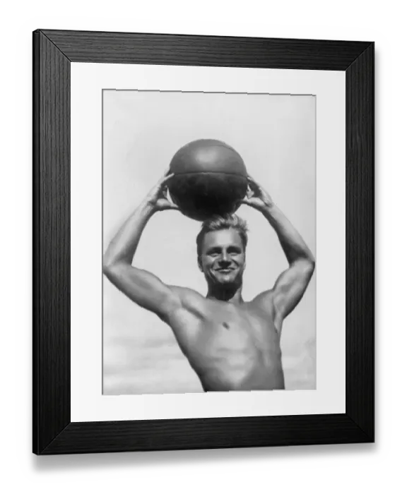 Framed Print : Atlas. circa 1930: A German athlete poses with a beach ball Framed Print : Atlas. circa 1930: A German athlete poses with a beach ball