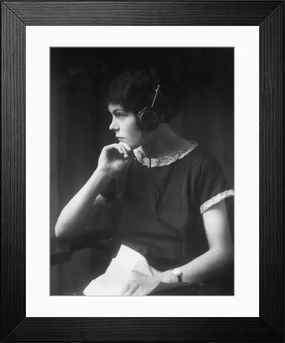 Framed Print : Listener. circa 1930: A girl wearing headphones Framed Print : Listener. circa 1930: A girl wearing headphones