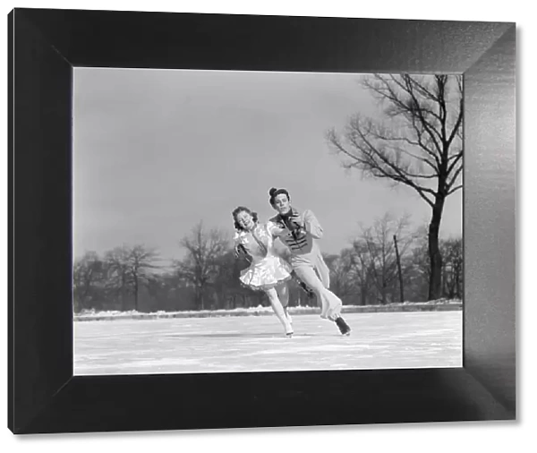 Man Woman Couple Pair Figure Skating On Ice Rink Smiling Costumes Arm In Arm Leaning Precision Glide Dance
