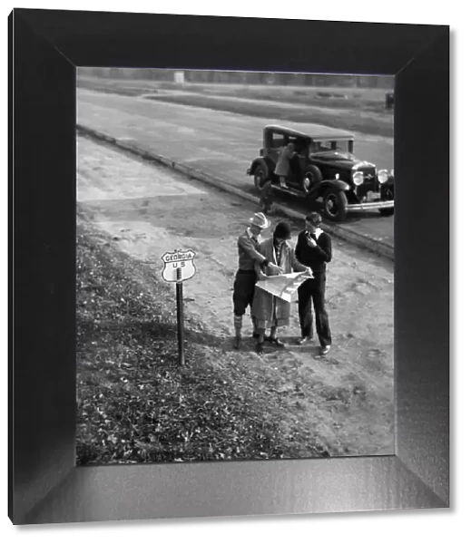 Family consulting road map on Georgia highway, USA (B&W)