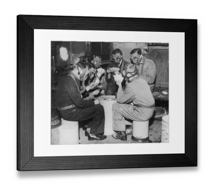 Framed Print : Group of men playing cards, wearing gas masks (B&W) Framed Print : Group of men playing cards, wearing gas masks (B&W)