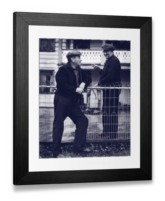 Framed Print : Two mature men talking over fence (B&W) Framed Print : Two mature men talking over fence (B&W)