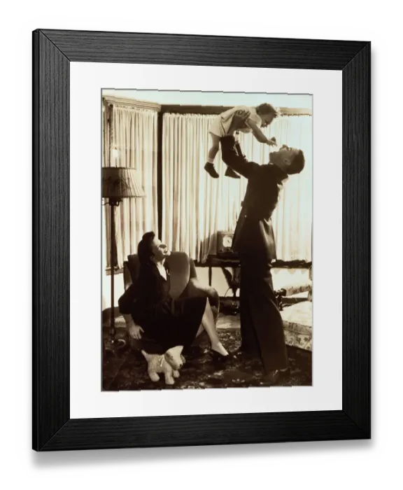 Framed Print : Mother watching father lifting toddler (18-21 months) (B&W sepia tone)