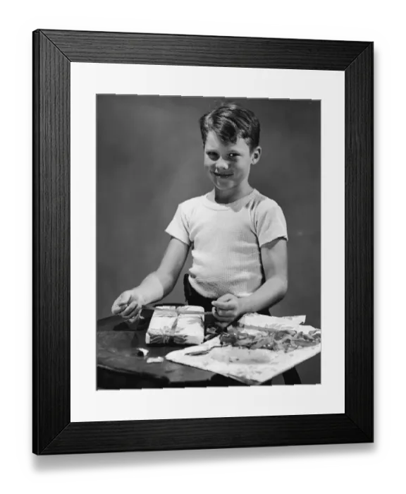 Framed Print : Boy (11-13) wrapping gift, portrait (B&W) Framed Print : Boy (11-13) wrapping gift, portrait (B&W)