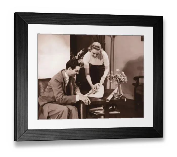 Framed Print : Woman showing brochure to man (B&W sepia tone) Framed Print : Woman showing brochure to man (B&W sepia tone)